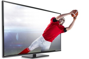 A man is playing football on the television.